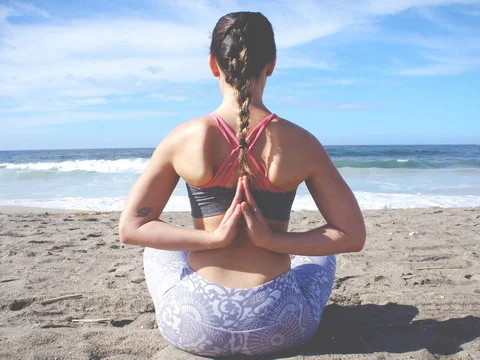 Yoga in Reverse Prayer Pose on the Beach
